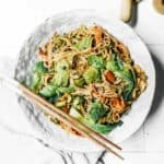 Bowl of Vegan Soba Noodle Salad sitting on counter with chopsticks.