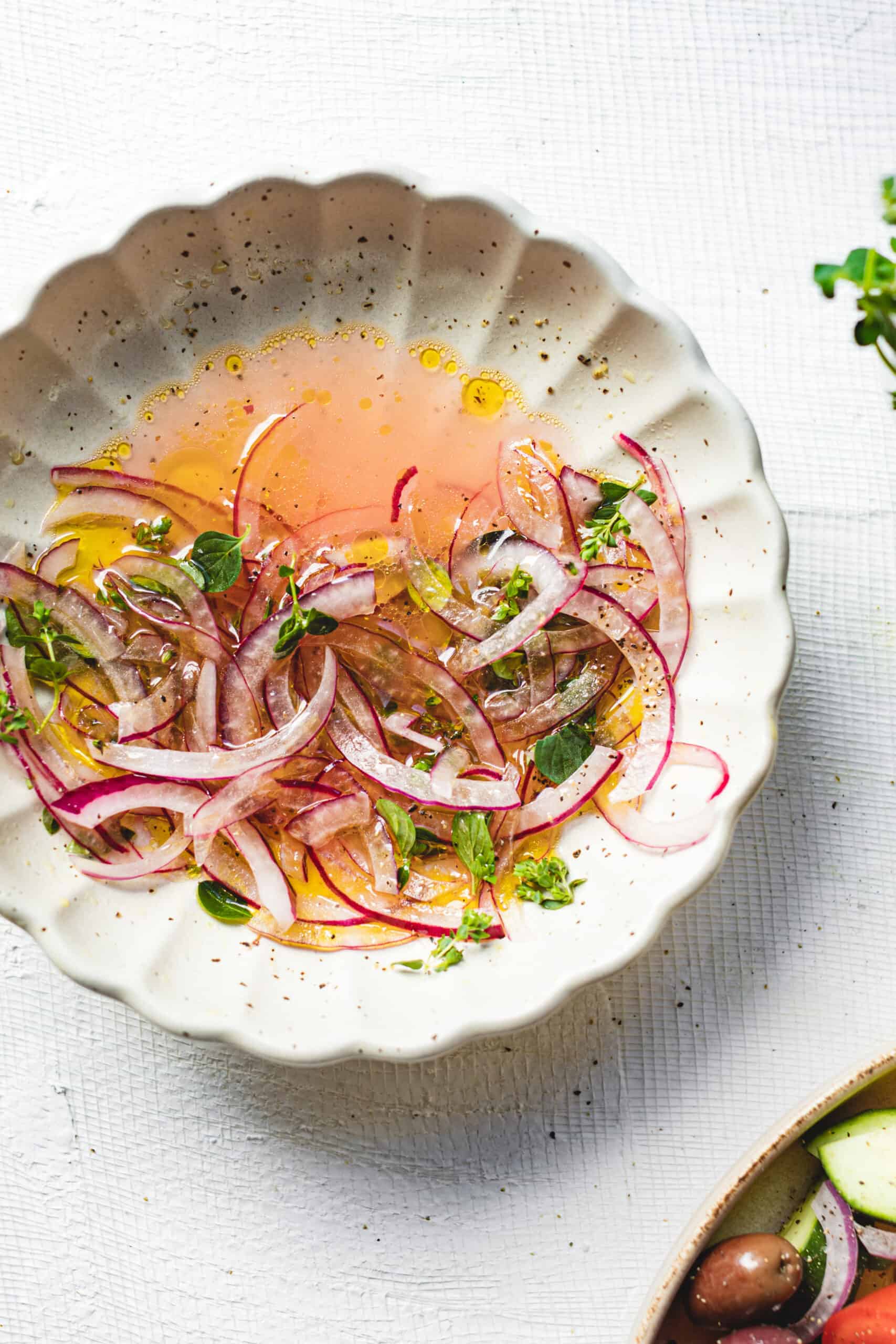 Beautifully colorful Quick Pickled Onions on a white plate for the how to pickle onions instructions