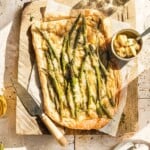 Asparagus and Cheese Tart on cutting board with sun shining through window.
