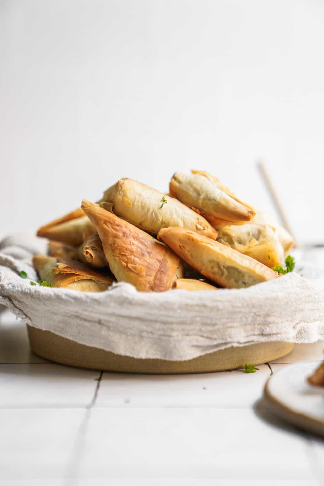 Side angle of spinach pies in a basket