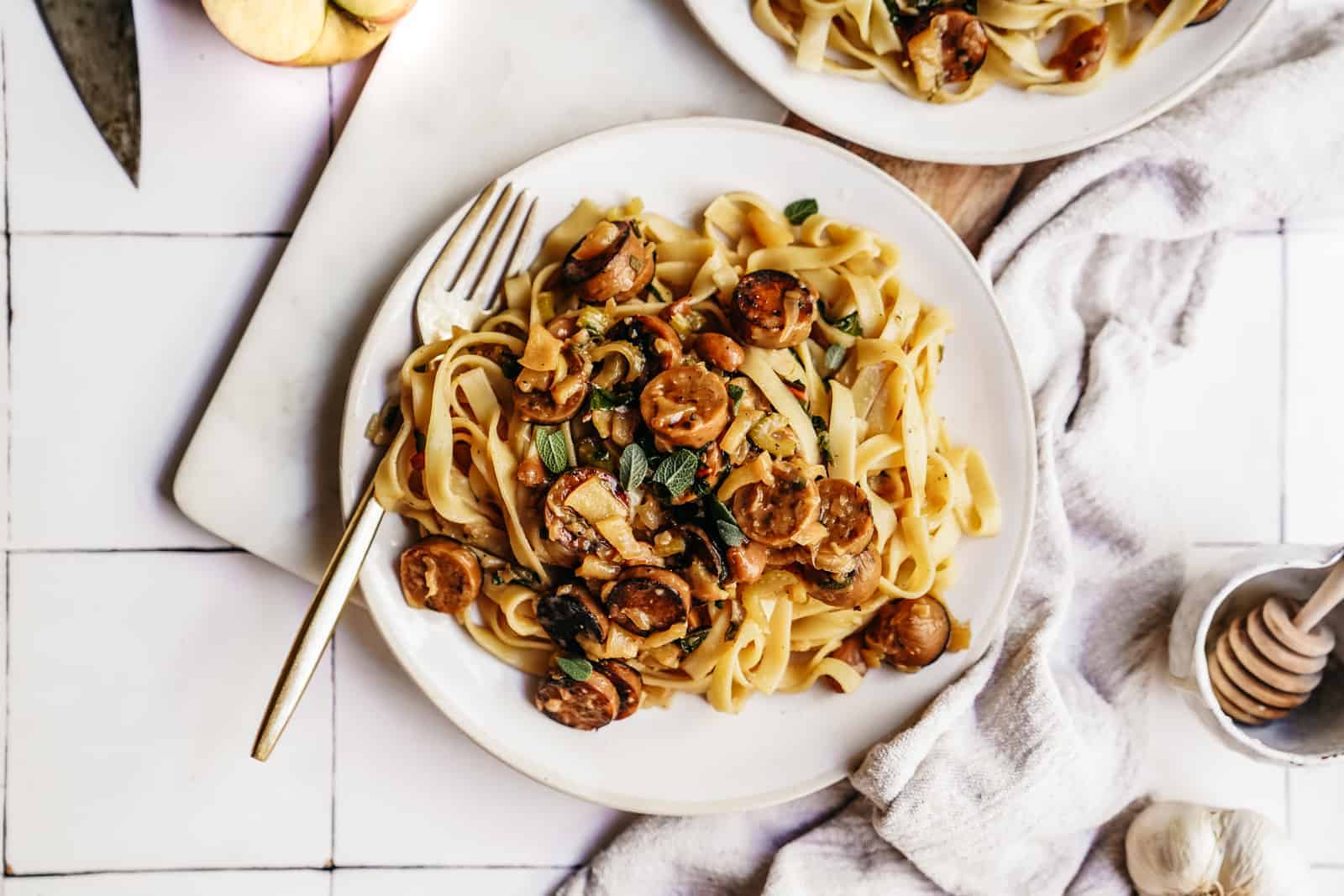 Easy Vegan Pasta Recipe - Sausage Pasta with Apple & Sage on a plate on the counter