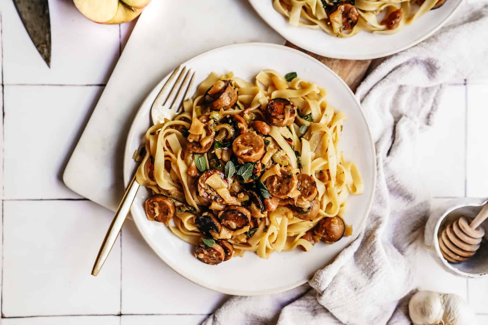 Plate of Vegan Sausage Pasta on white counter. Perfect for meal prep.