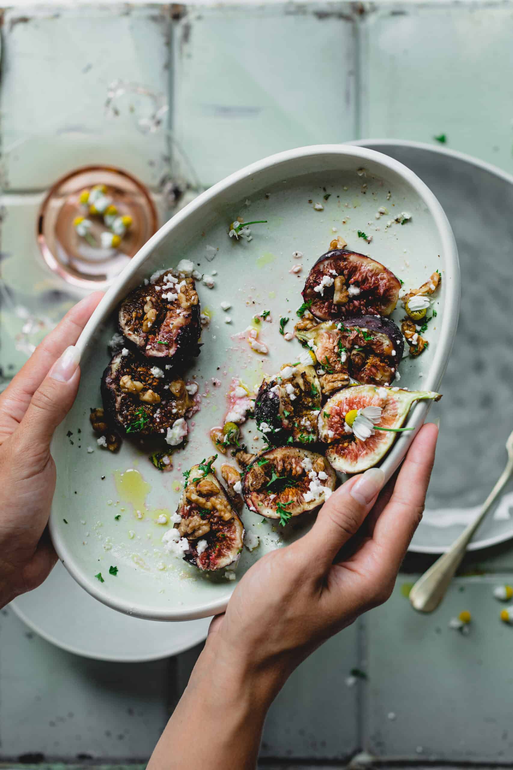 Hands holding a bowl of Simple Fresh Fig Salad