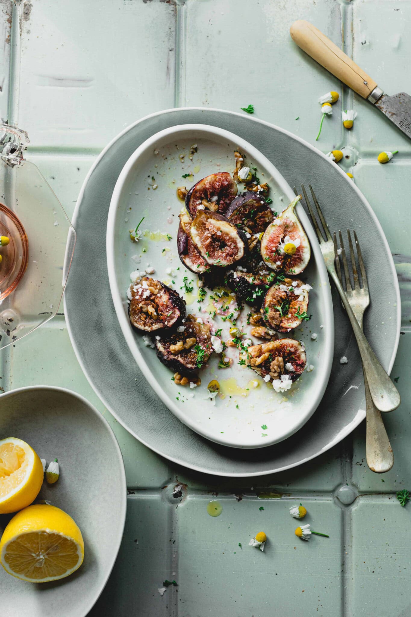Big Fresh Bowl of Simple Fresh Fig Salad on a counter with lemon