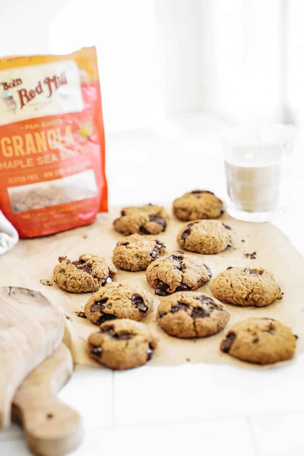 Granola Chocolate Chip Cookies scattered on counter with bag of Bob's Red Mill Granola