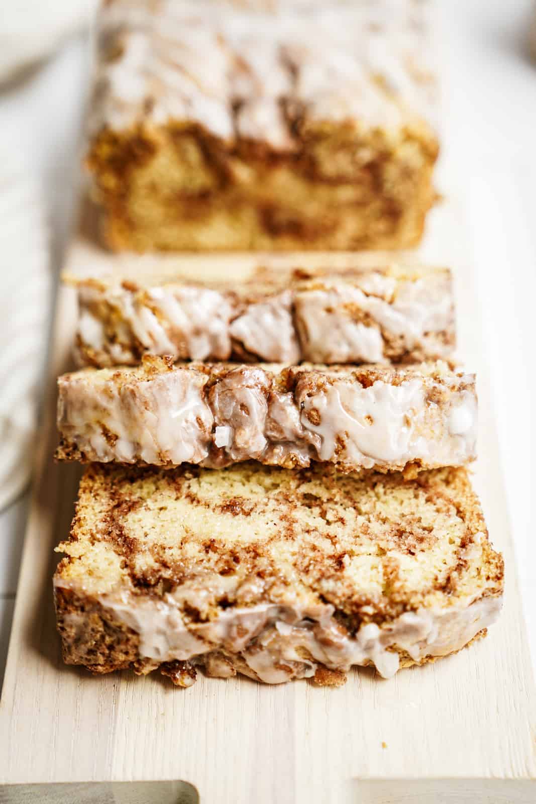 Vegan Cinnamon Bun Bread sliced on cutting board