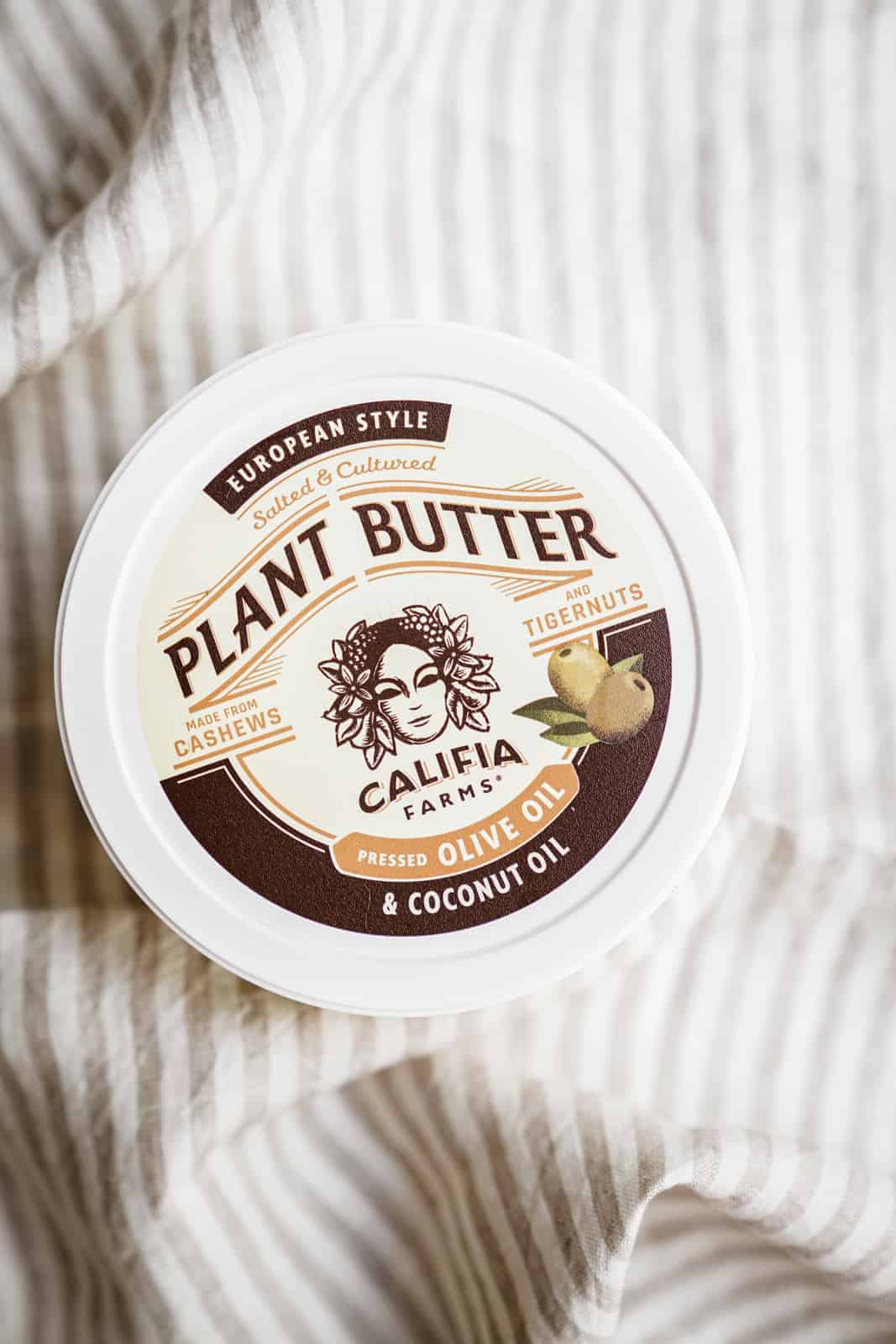Container of Califia Farms Plant Butter made with Olive Oil on cloth