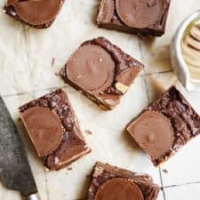 Cut up squares on counter with knife of Chocolate Peanut Butter Fudge
