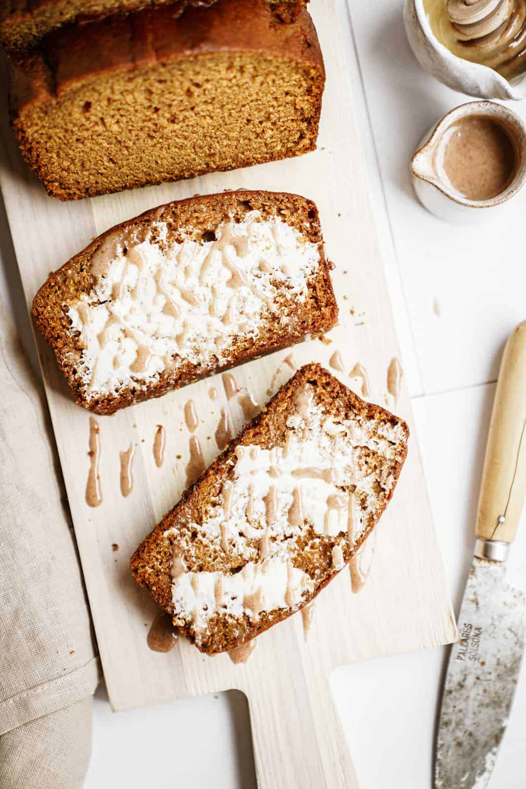 Sliced vegan pumpkin bread on cutting board