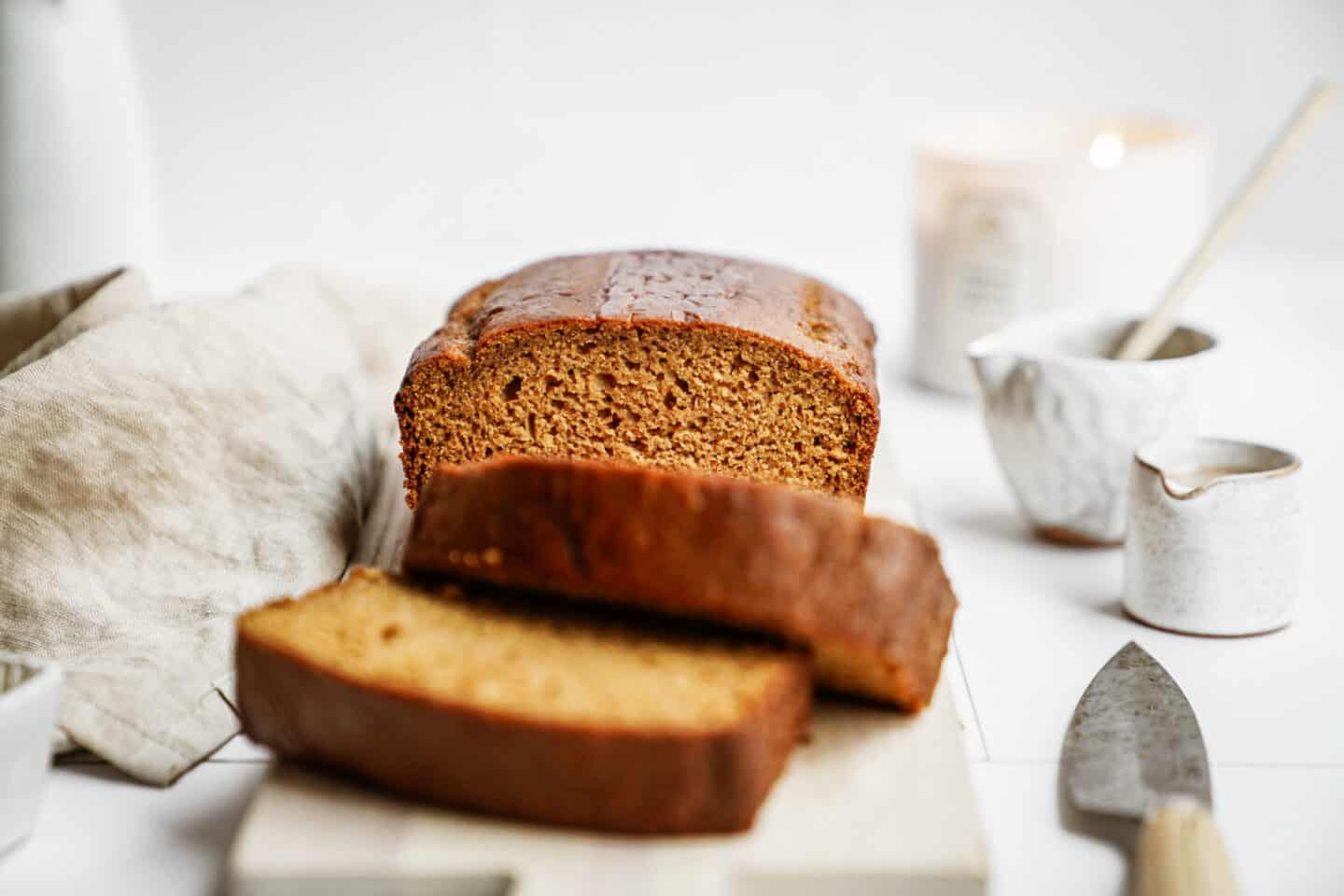 vegan pumpkin bread sliced on a cutting board