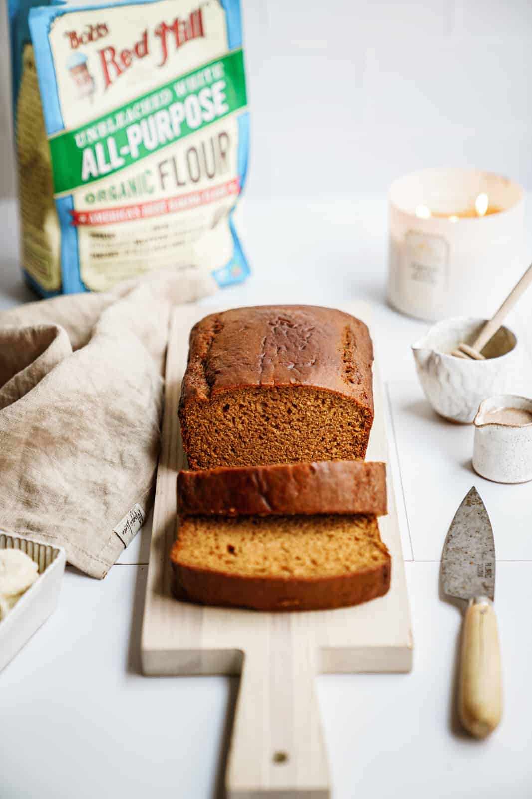 vegan pumpkin bread with bag of Bob's Red Mill flour in the back.