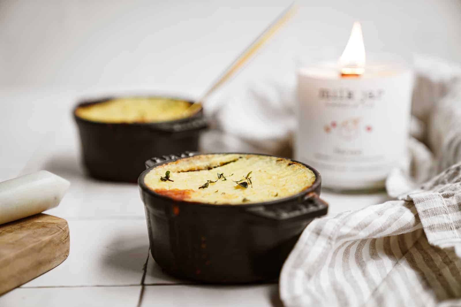 Side shot of Lentil Shepherd's Pie with candle in background