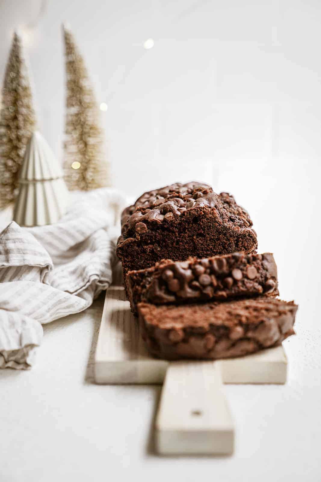 Vegan chocolate banana bread sliced on cutting board