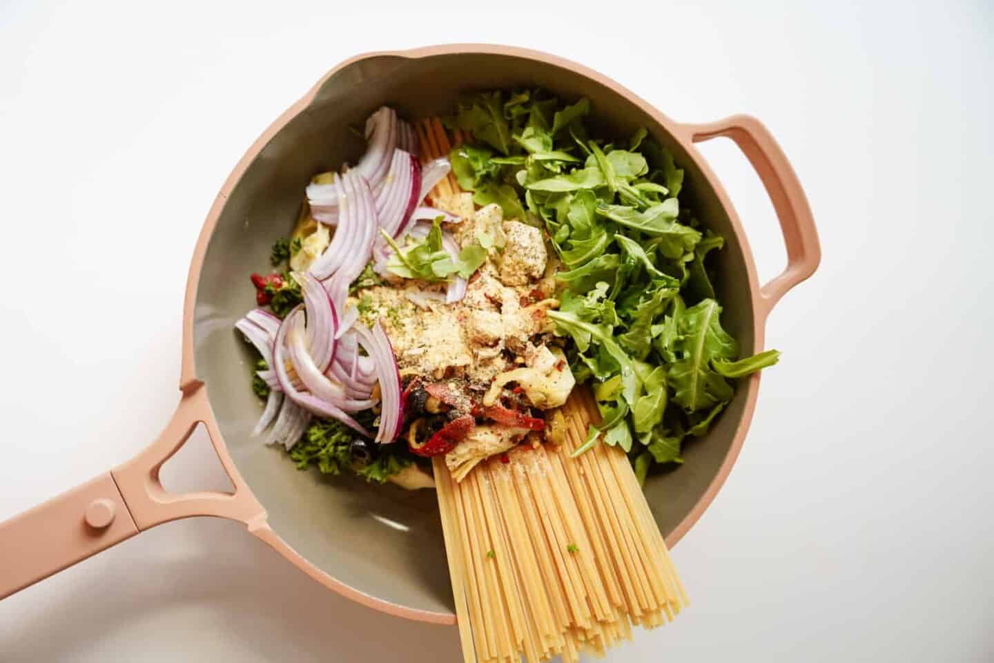 Fresh ingredients in one pot for one-pot vegetarian Greek pasta.