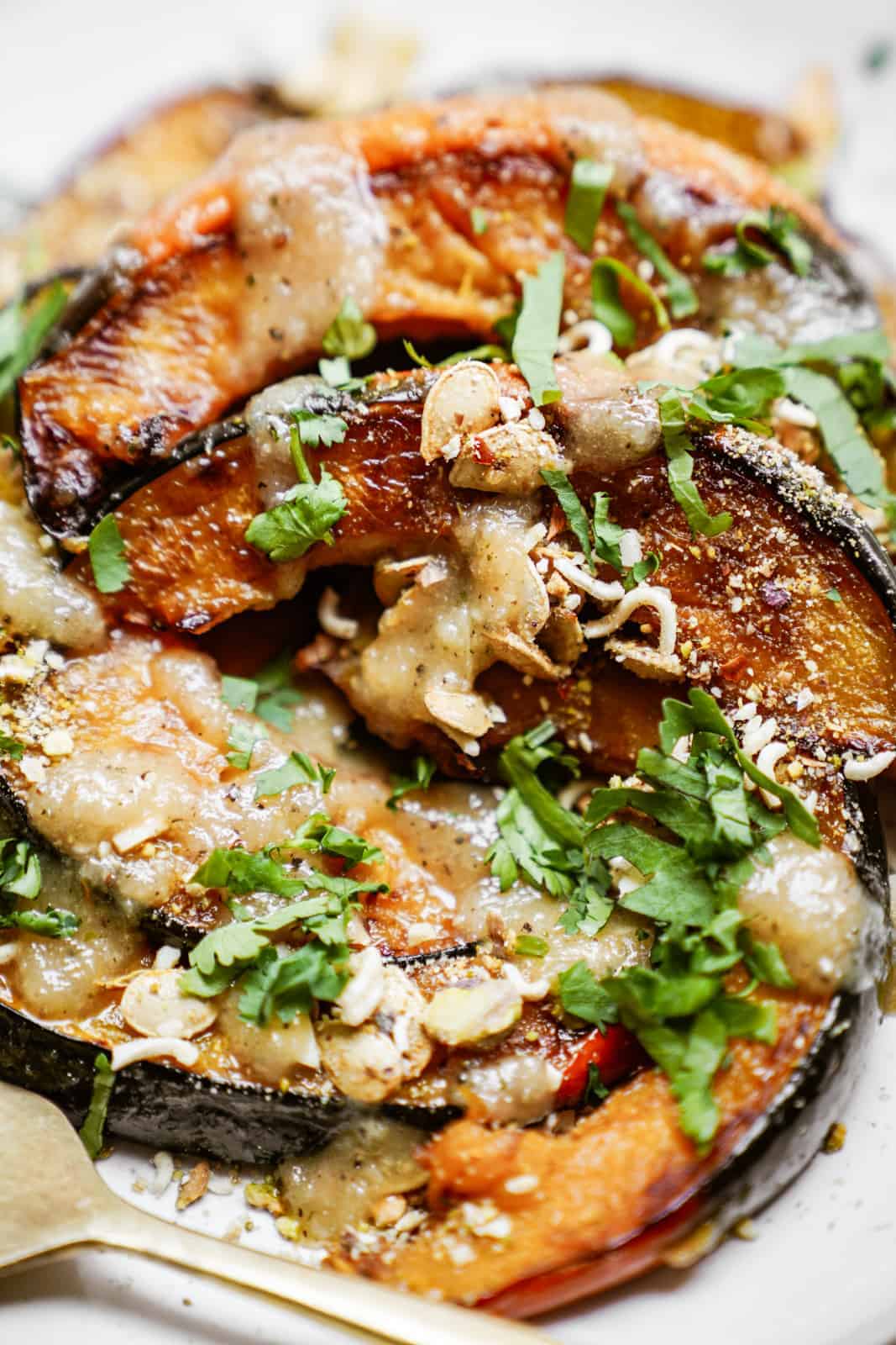 Close-up of roasted acorn squash recipe full of texture and sprinkled with parsley.
