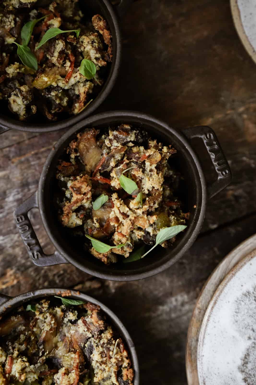 Gluten-Free Vegan Stuffing in mini pots on wooden table.