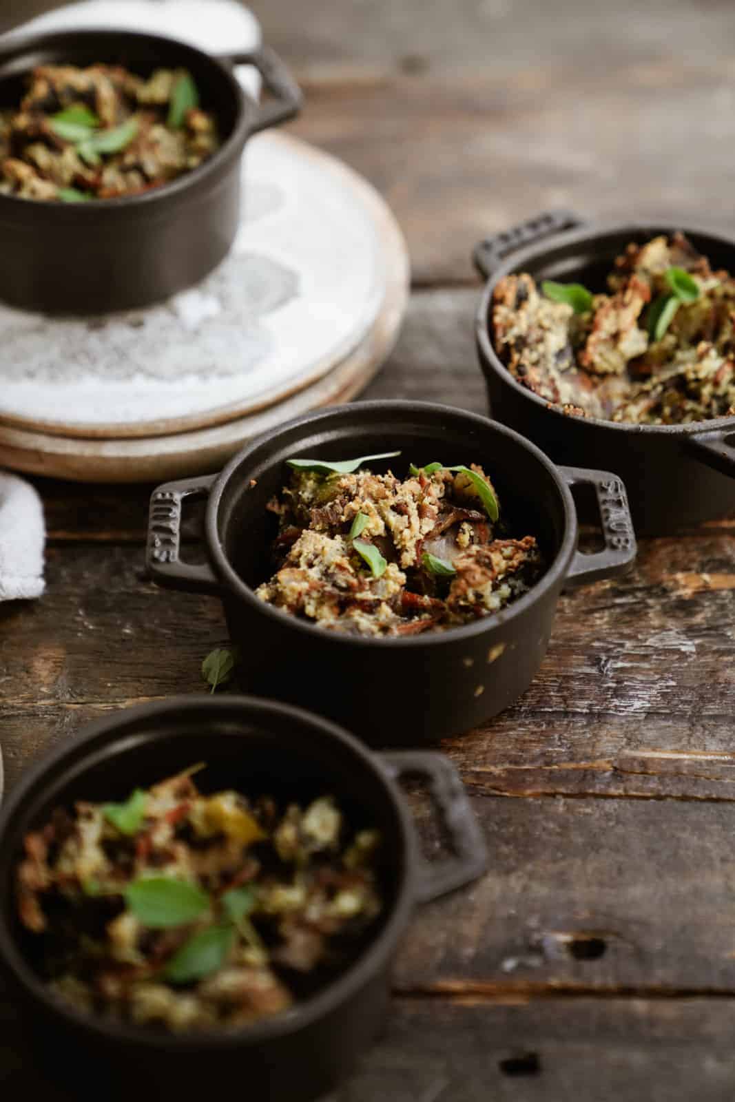 Gluten-Free Stuffing in mini pots on wooden table.