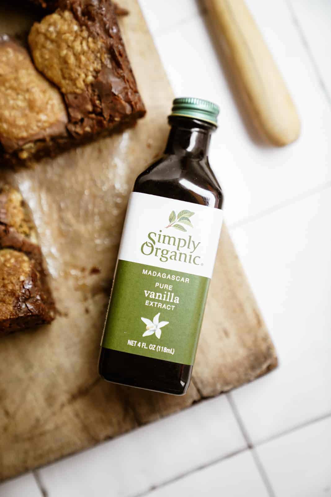 Bottle of Simply Organic Pure Vanilla Extract next to Oatmeal Fudge Bars