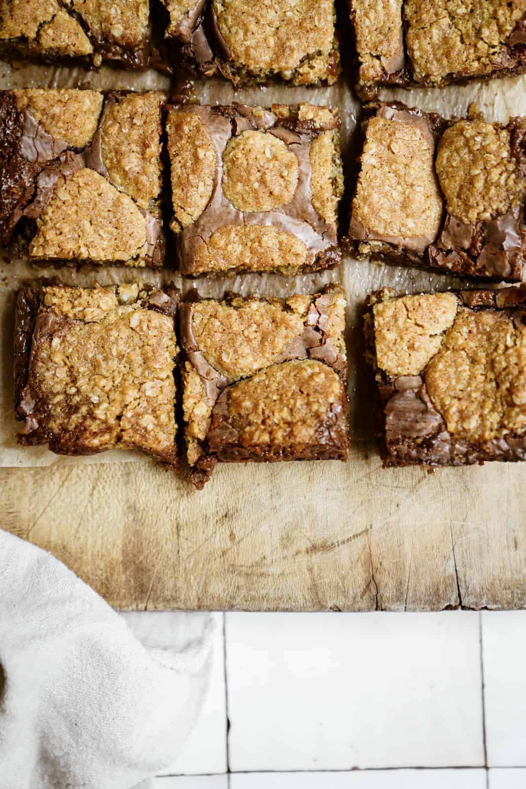 Cut Oatmeal Fudge Bars on a cutting board.