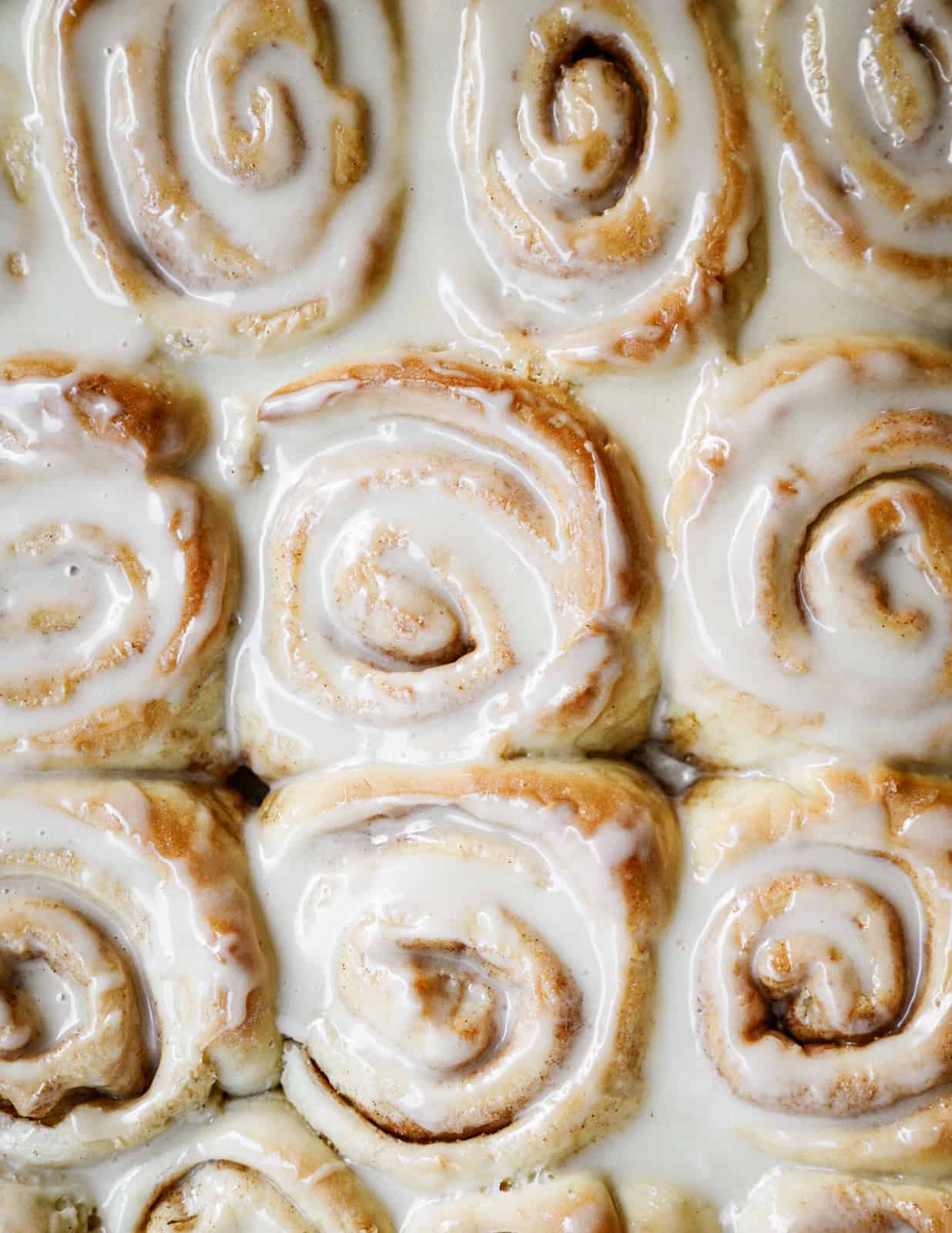 Vegan Cinnamon Buns shot from overheat with ooey gooey icing.