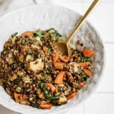 Lentils with Spinach in serving dish with spoon in the bowl