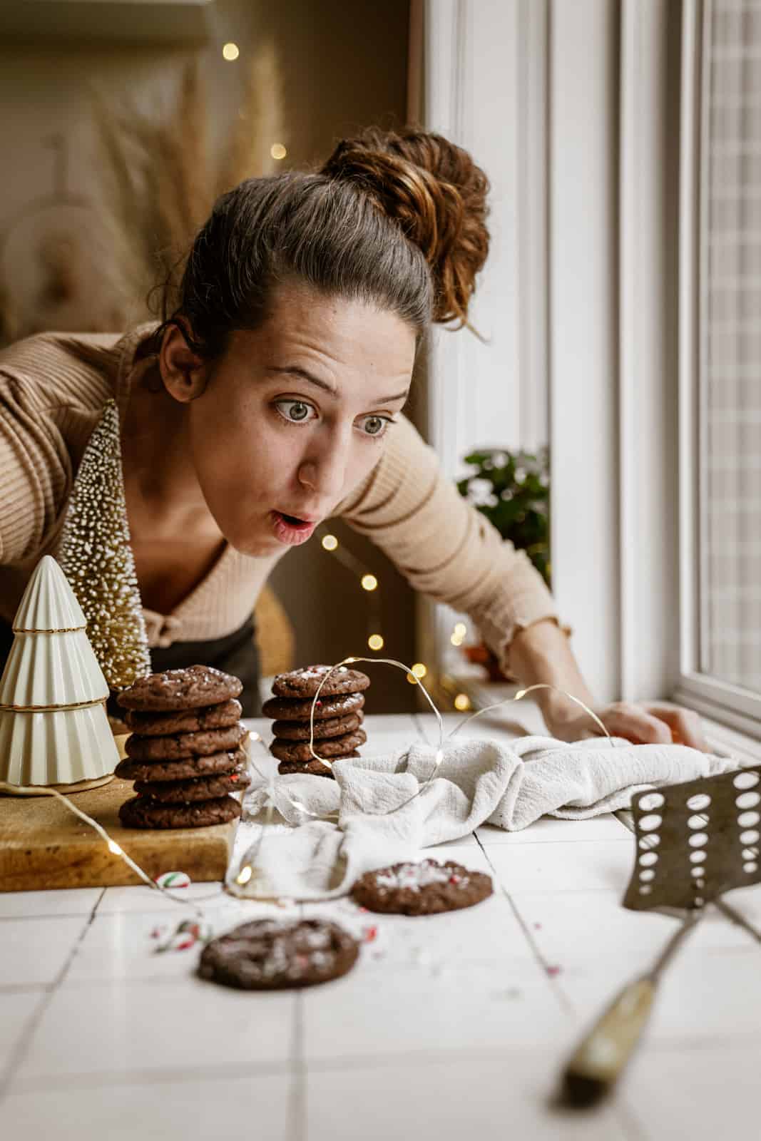 Maria's sister looking at Chocolate Peppermint Cookies on countertop.