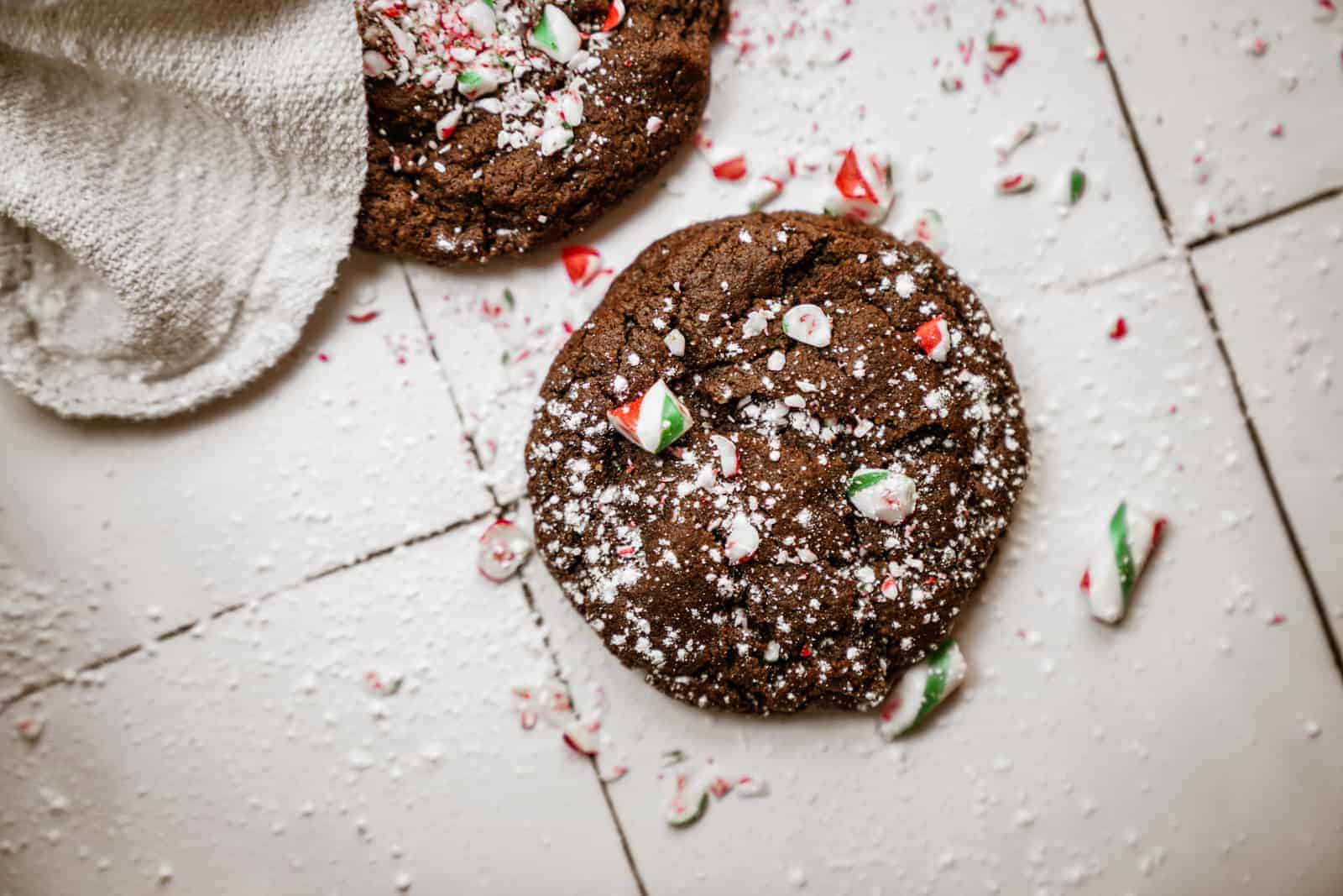 Close-up of Chocolate Peppermint Cookies with sprinkled candy cane on top.