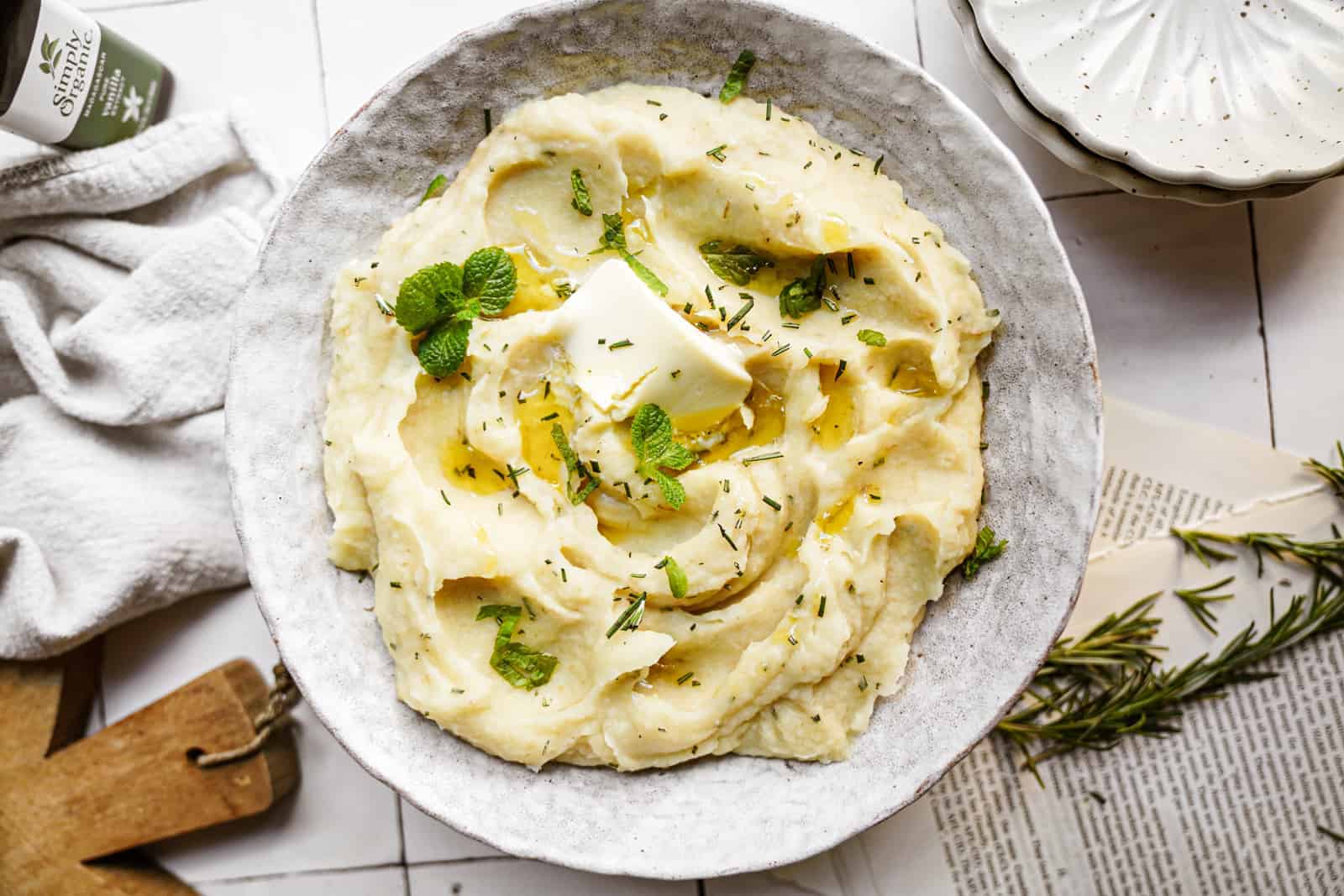 Parsnip Mashed Potatoes in serving bowl with melted vegan butter on top.