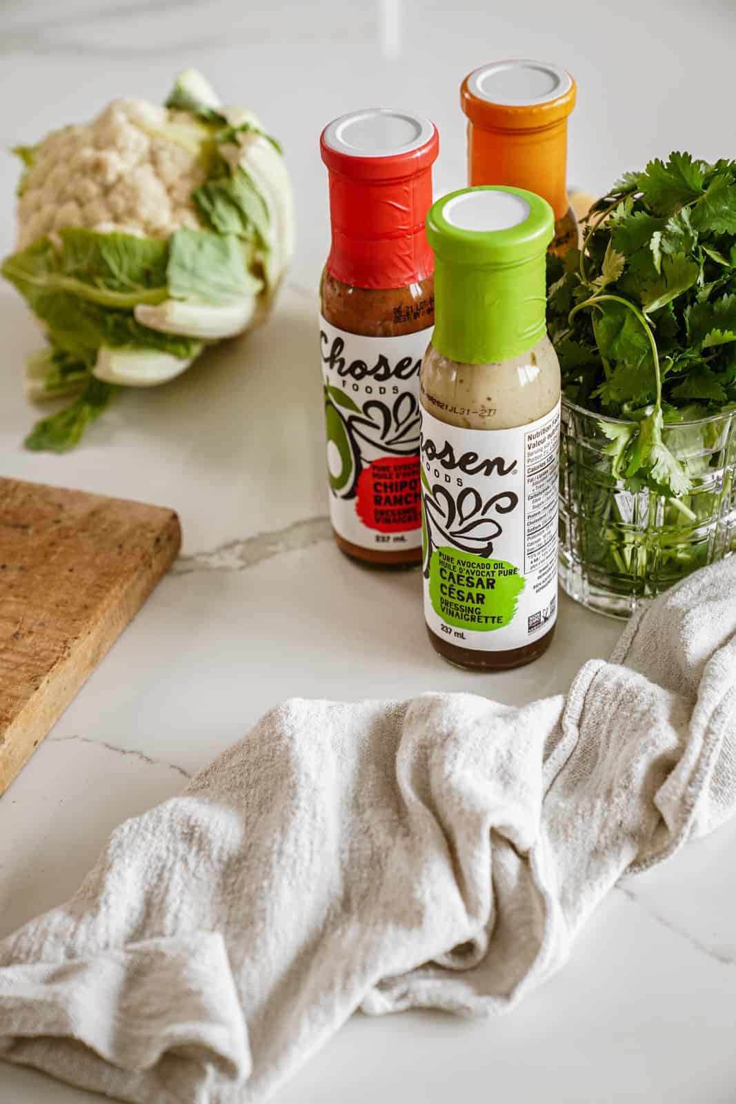 Chosen Foods salad dressings on countertop for baked tofu power bowl