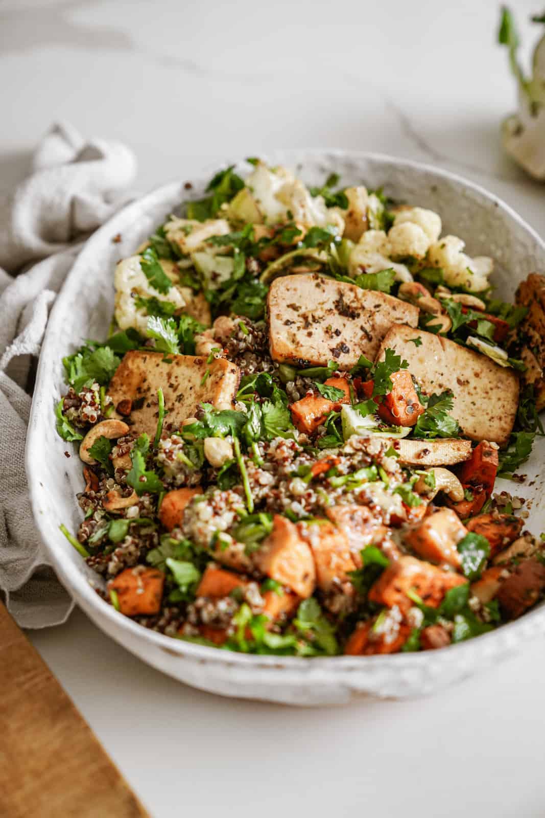 Tofu power bowl on countertop in white serving bowl