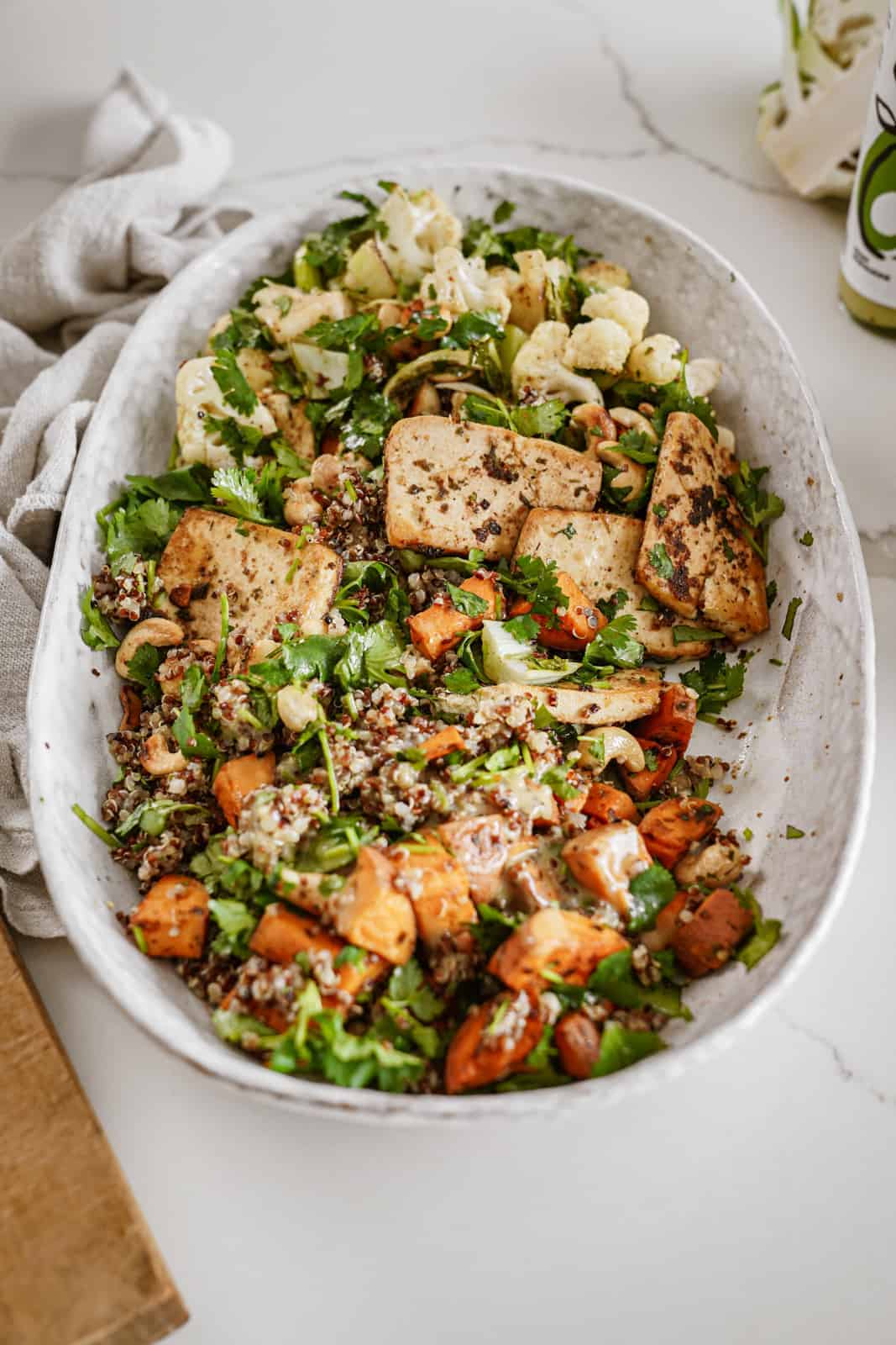 Tofu power bowl on countertop in white serving bowl