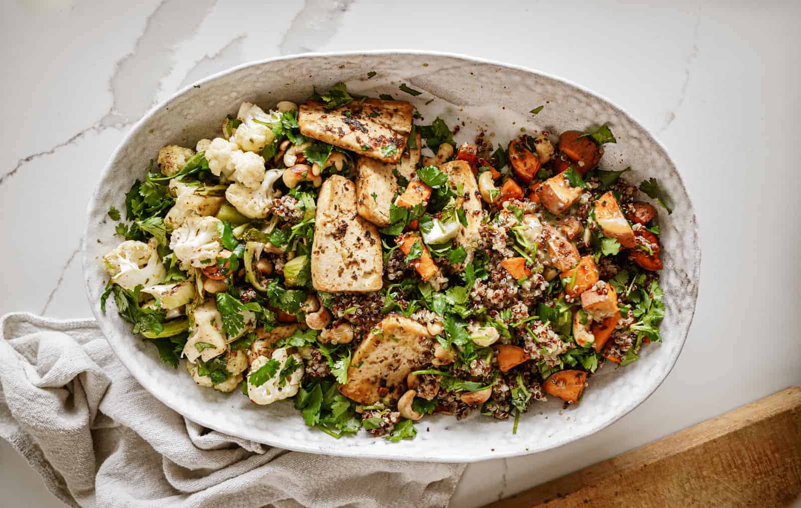 Tofu power bowl on countertop in white serving bowl