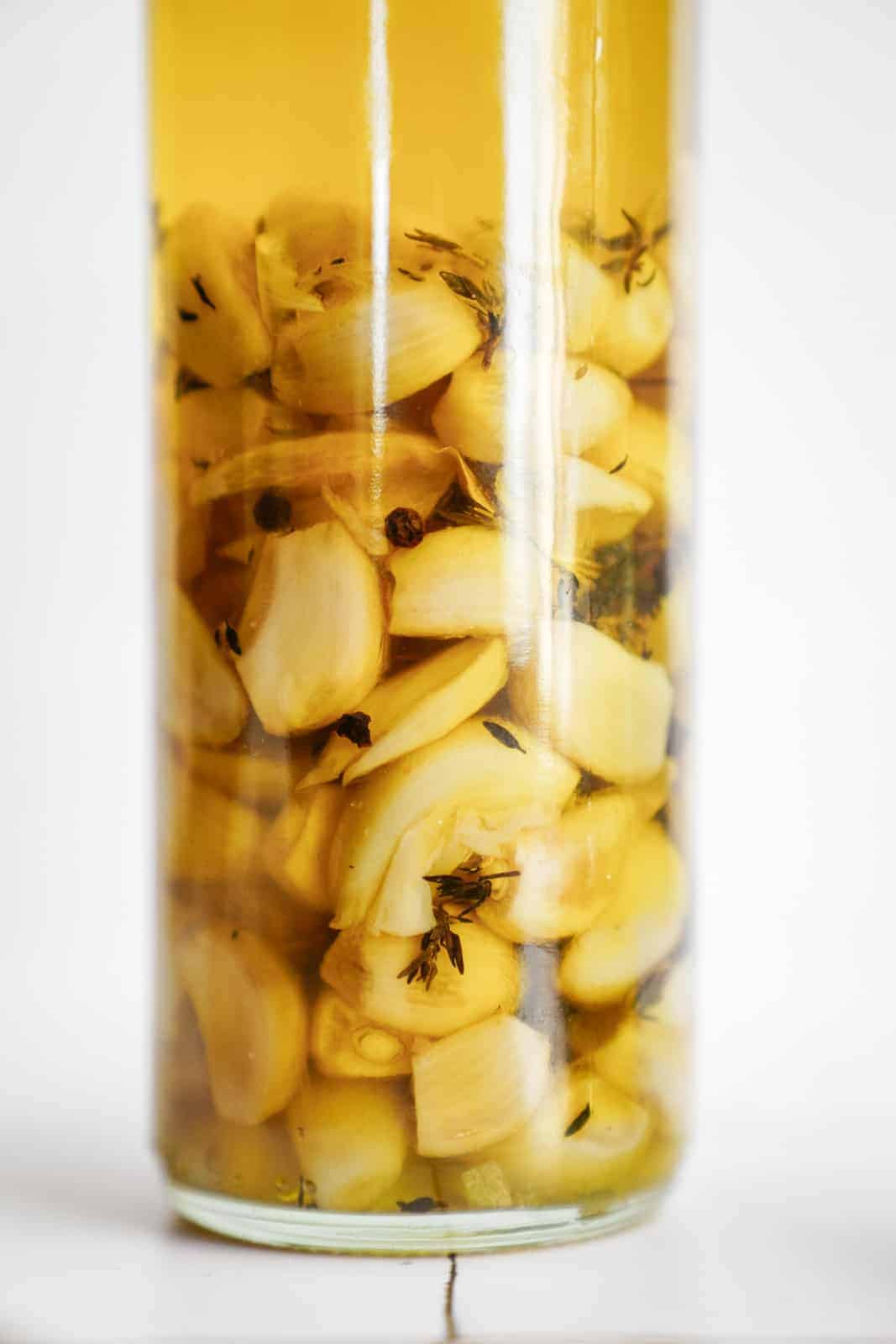 Close-up of garlic confit in infused olive oil