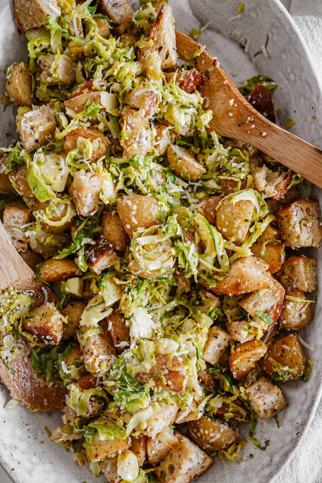 Big bowl of summer salad with a serving spoon in it.