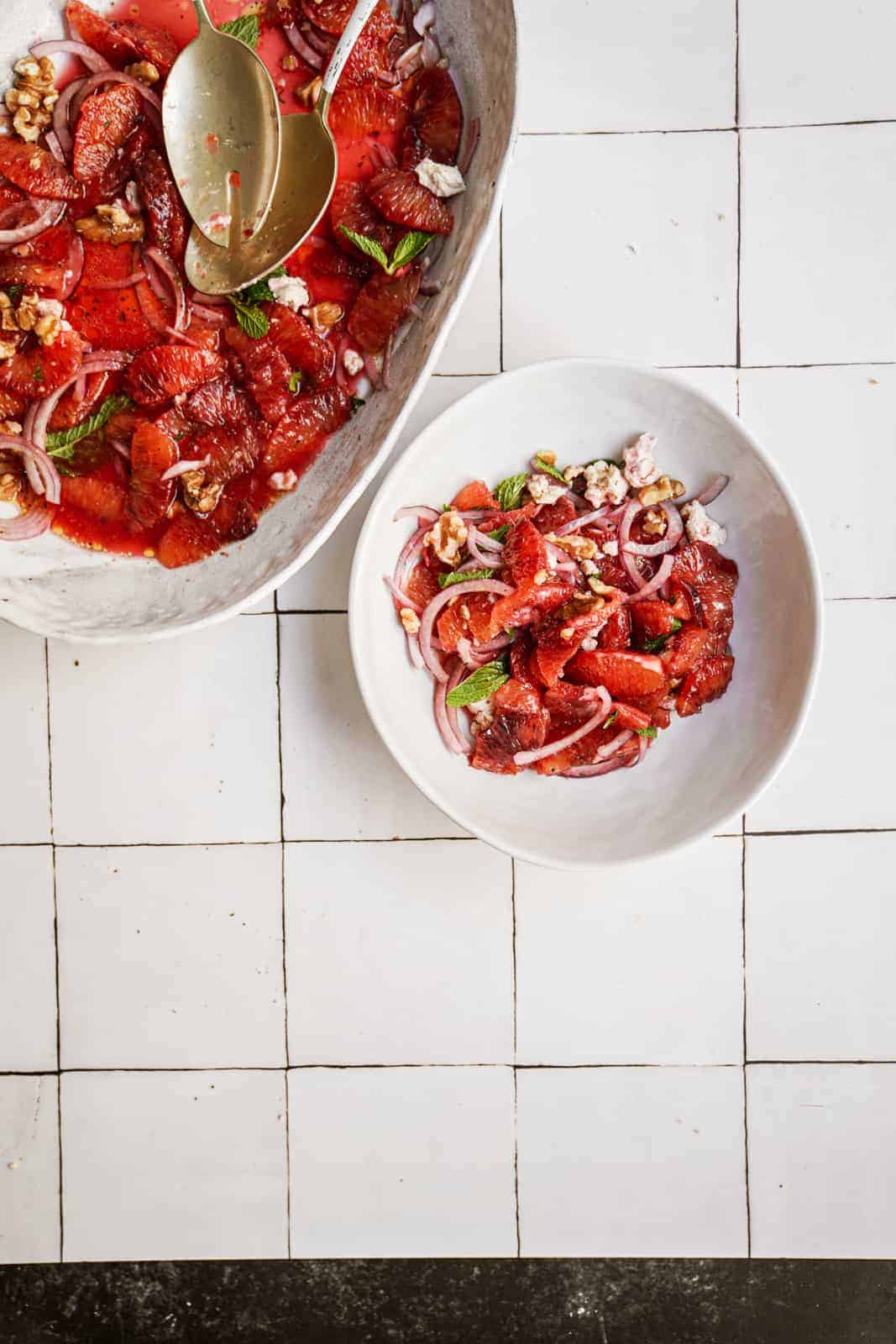 Blood orange salad on white countertop in a serving dish