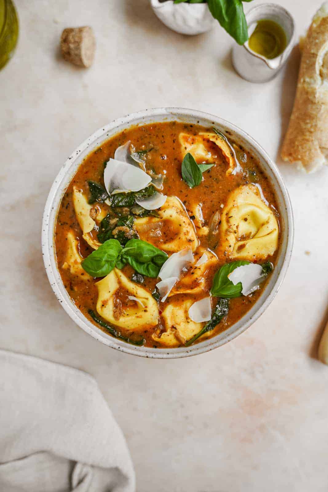 Big bowl of vegan tortellini soup on countertop