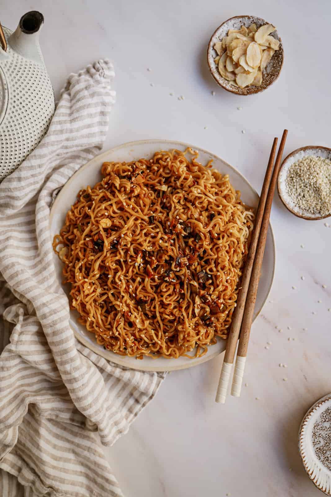 A plate of Vegan Garlic Noodles on a plate with chopsticks