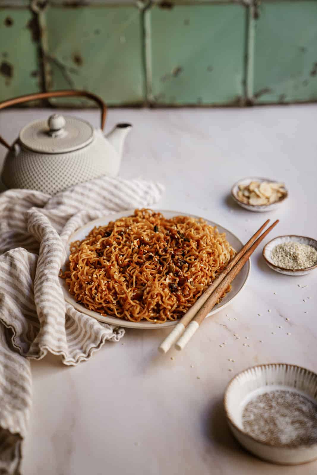 Vegan Sesame Garlic Noodles on a plate with chopsticks