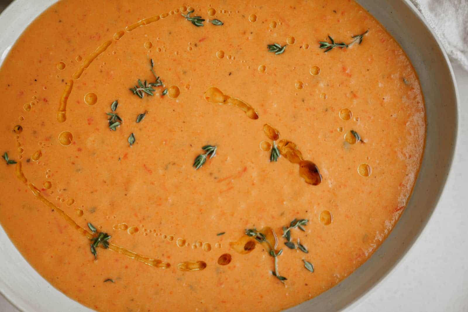 Big bowl of Roasted Red Pepper Soup on counter