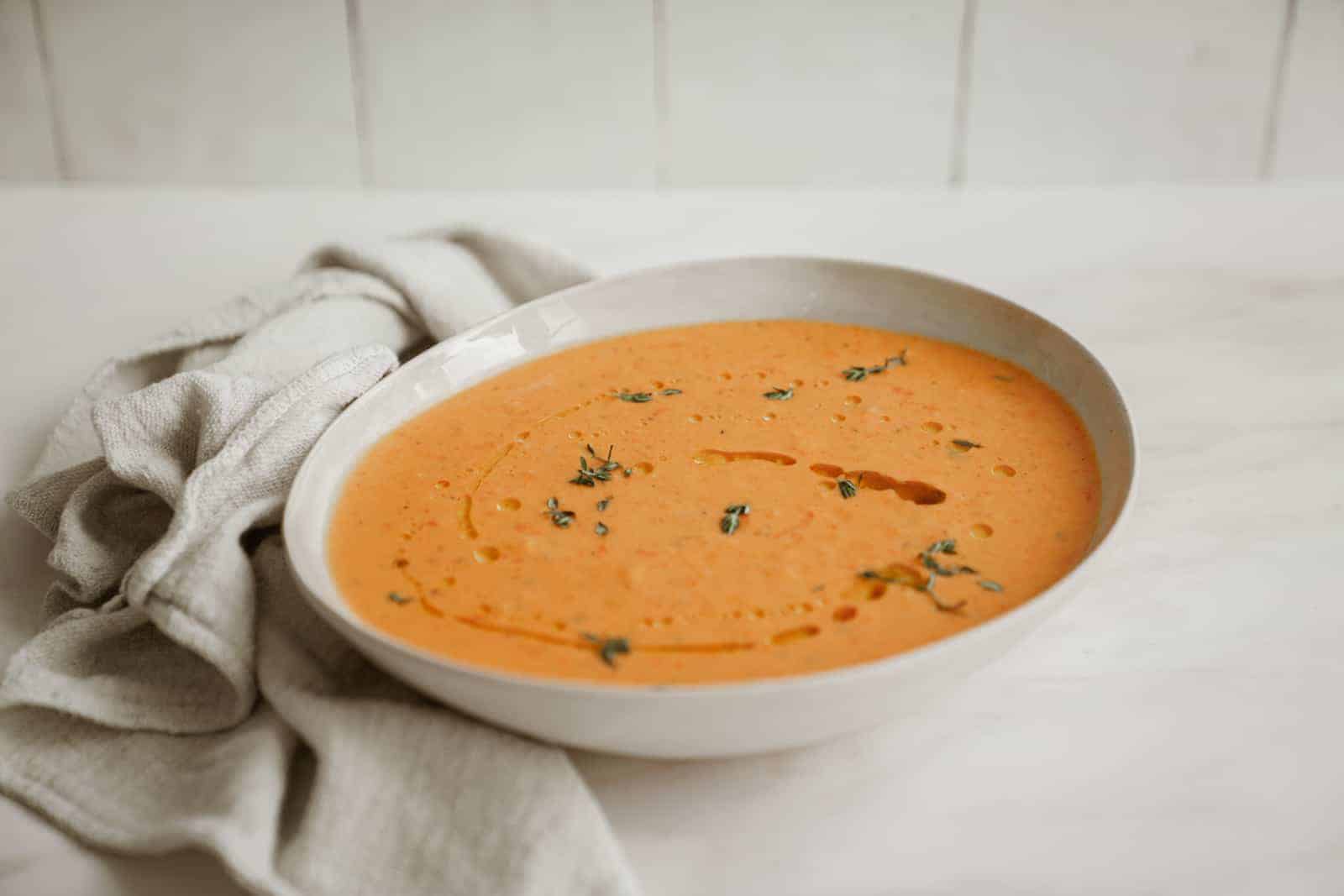 Big bowl of Roasted Red Pepper and Tomato Soup on counter