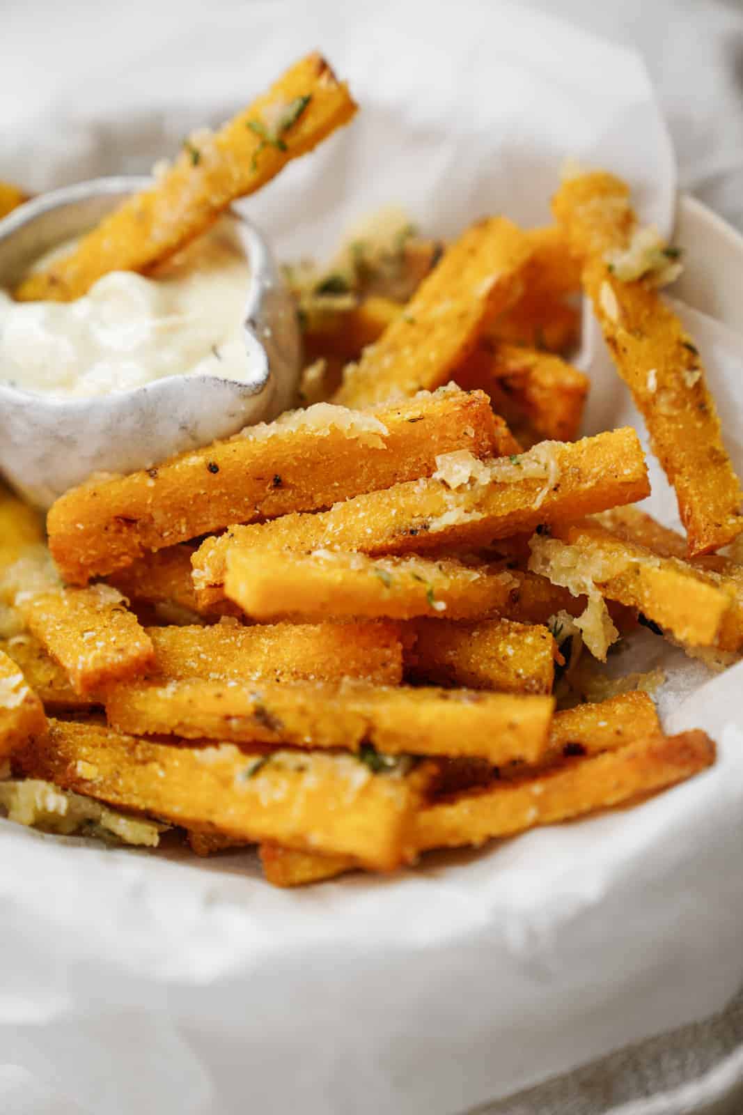 A bowl of vegan polenta fries with a side of vegan aioli