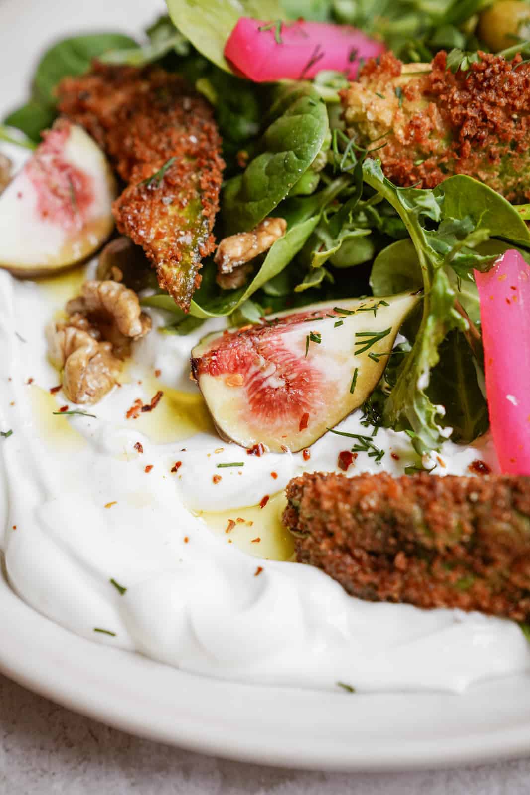 Close-up of fresh ingredients with fried avocado on a plate