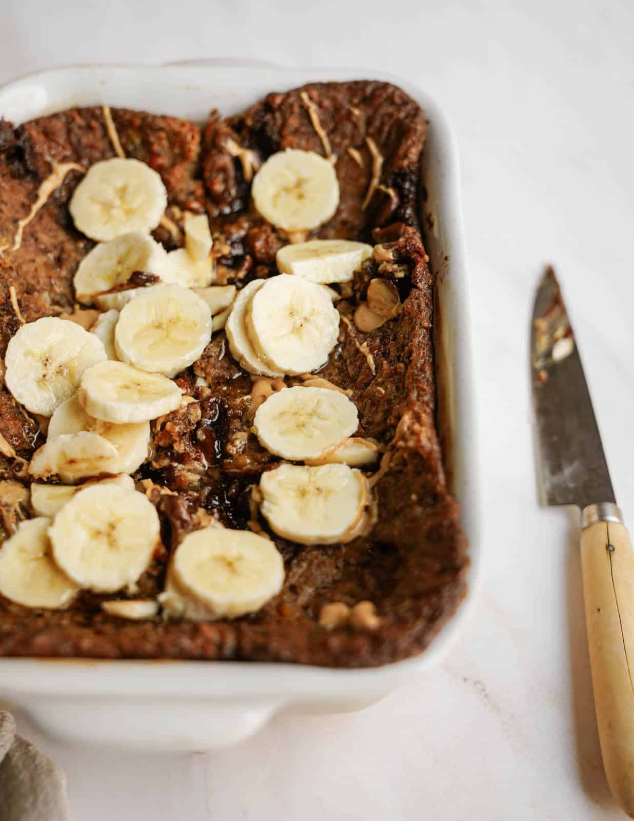 Vegan baked oatmeal with bananas cut on top.