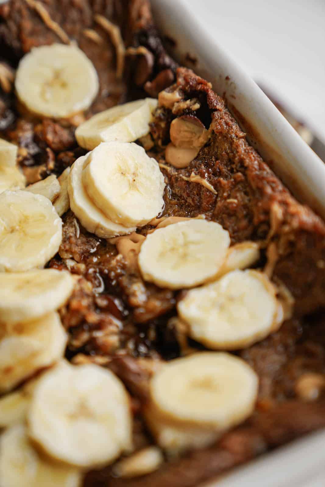 Vegan baked oatmeal with bananas cut on top.