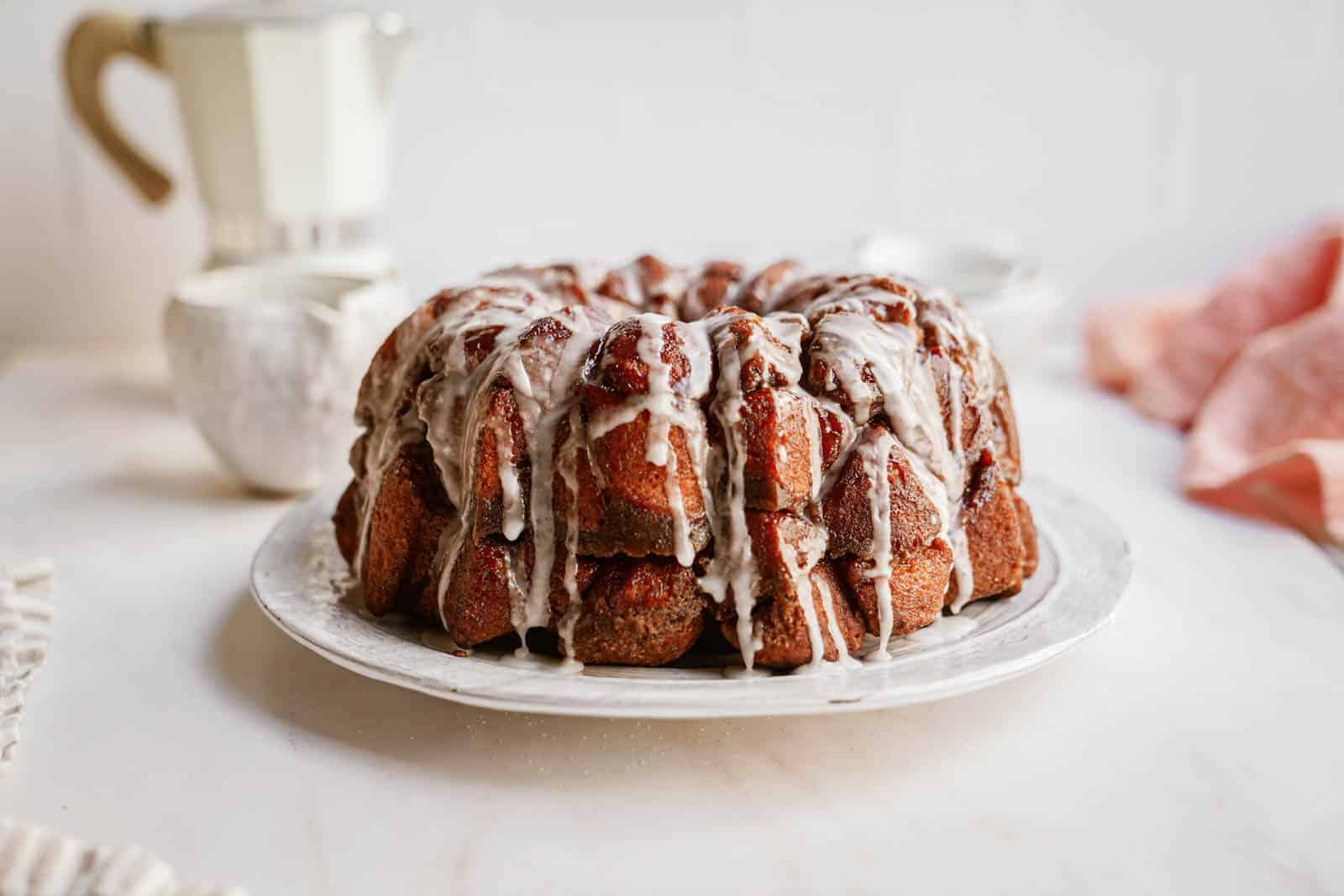 Vegan monkey bread on plate drizzled with icing