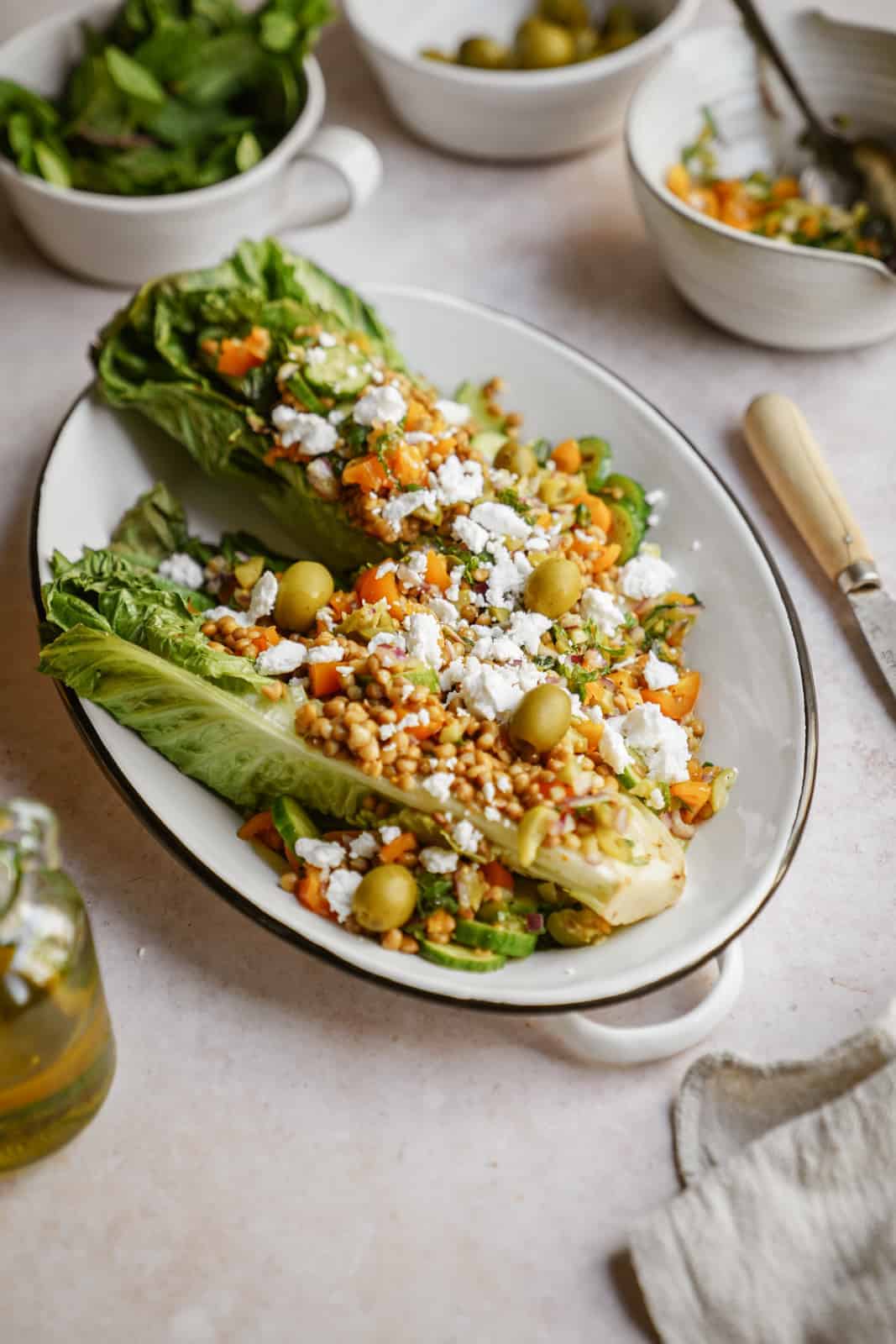 Grilled romaine salad with olive salsa and lentils on serving dish