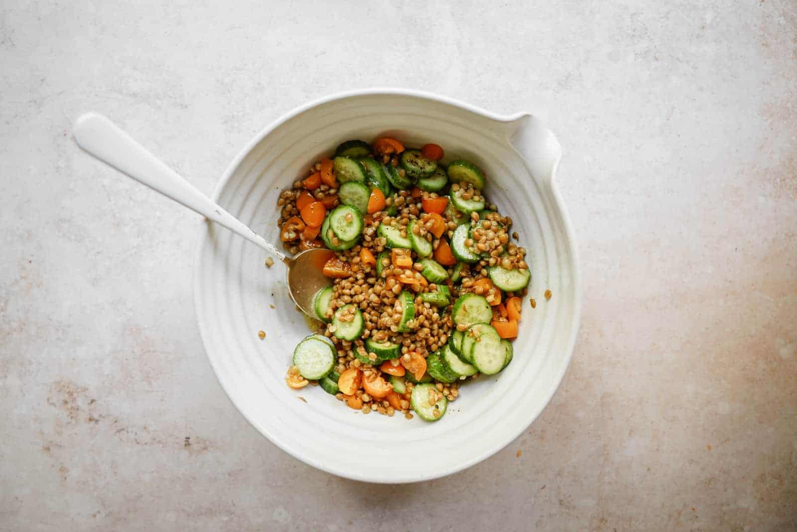 Step-by-step ingredients being added to a bowl for grilled romaine salad