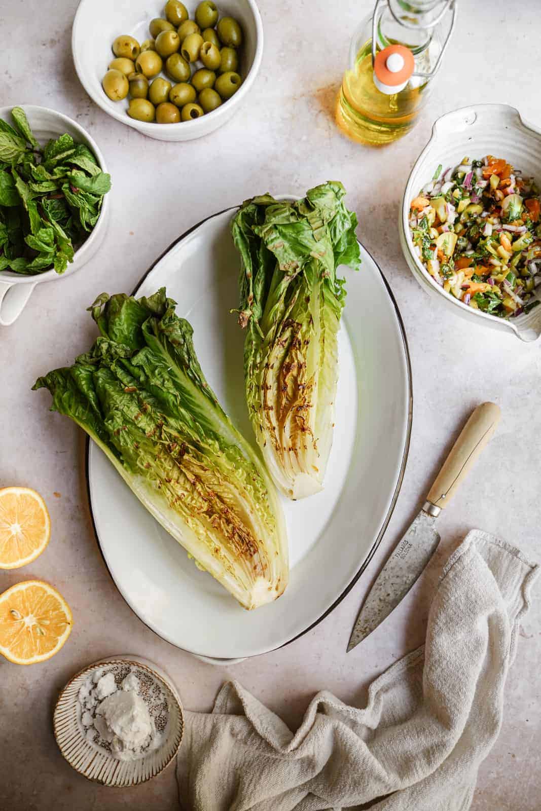 grilled romaine lettuce heads on a serving dish