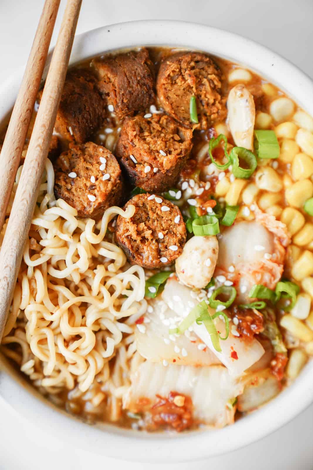 Vegan miso ramen bowl topped with vegan sausage