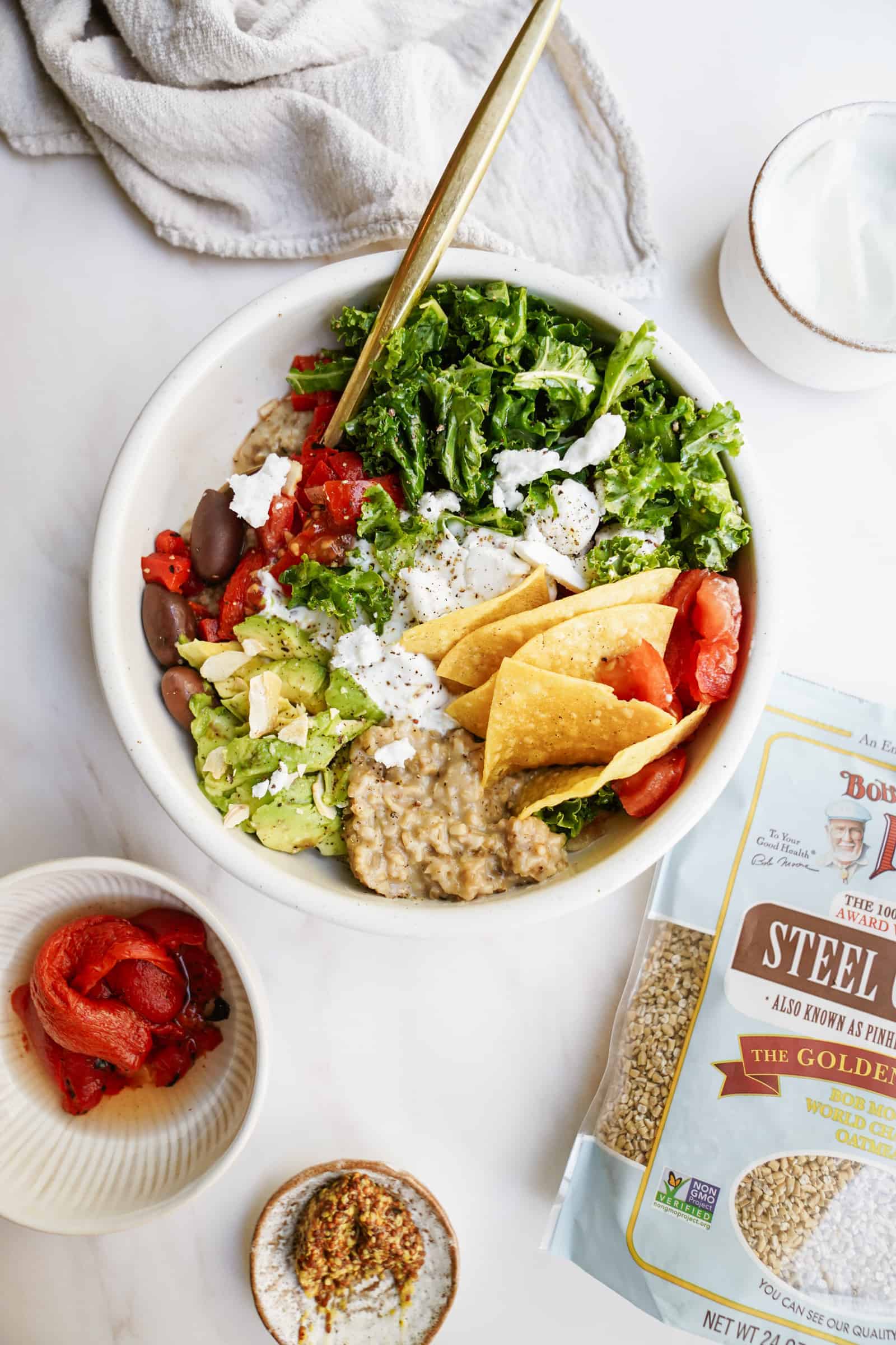 Savory steel cut oats with all the colourful toppings on countertop